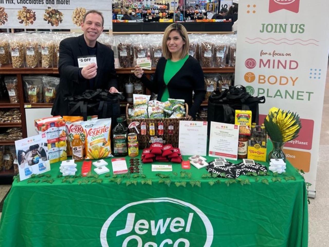 People posing at booth at Jewel-Osco Mind, Body, Planet event