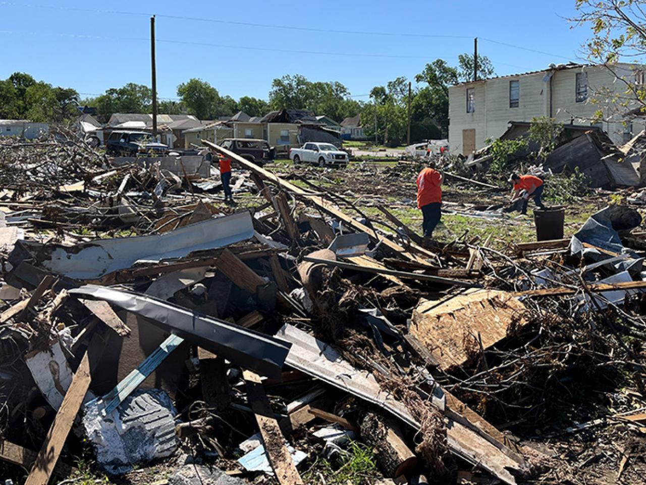 The Home Depot Foundation volunteers shown working through tornado damage in a community. 