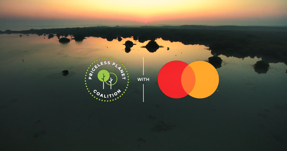 Sunset over a wetland landscape. Logos for Priceless Planet and Mastercard on top.