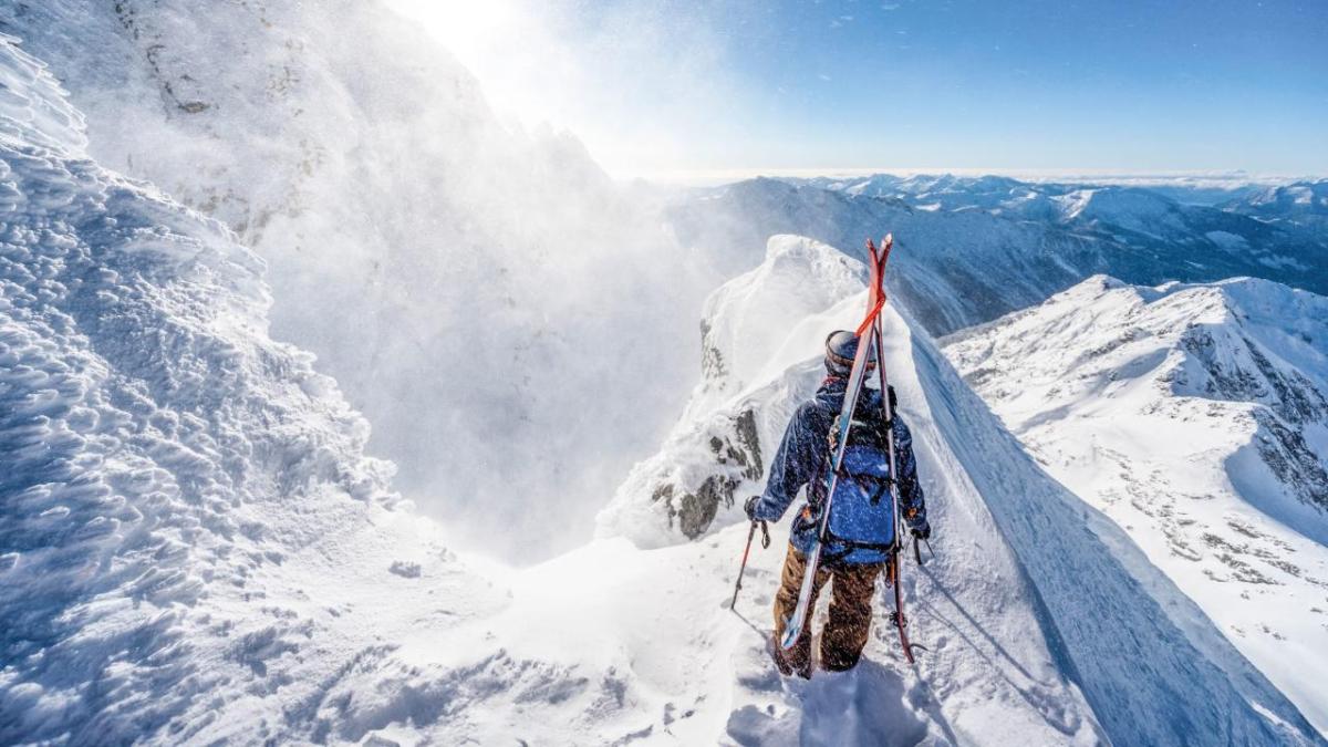 A person stood on top of a snowy mountain