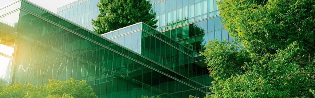A glass building surrounded by trees