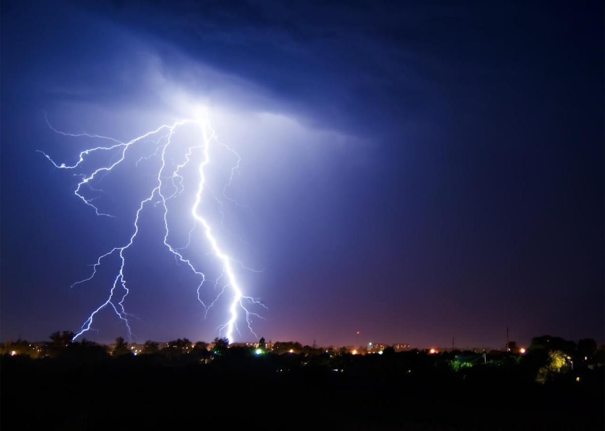 Nighttime lightning bolt above a cityscape 