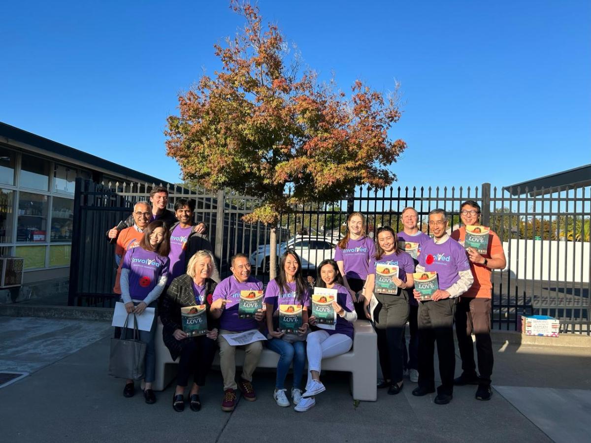 San Mateo volunteers holding up books