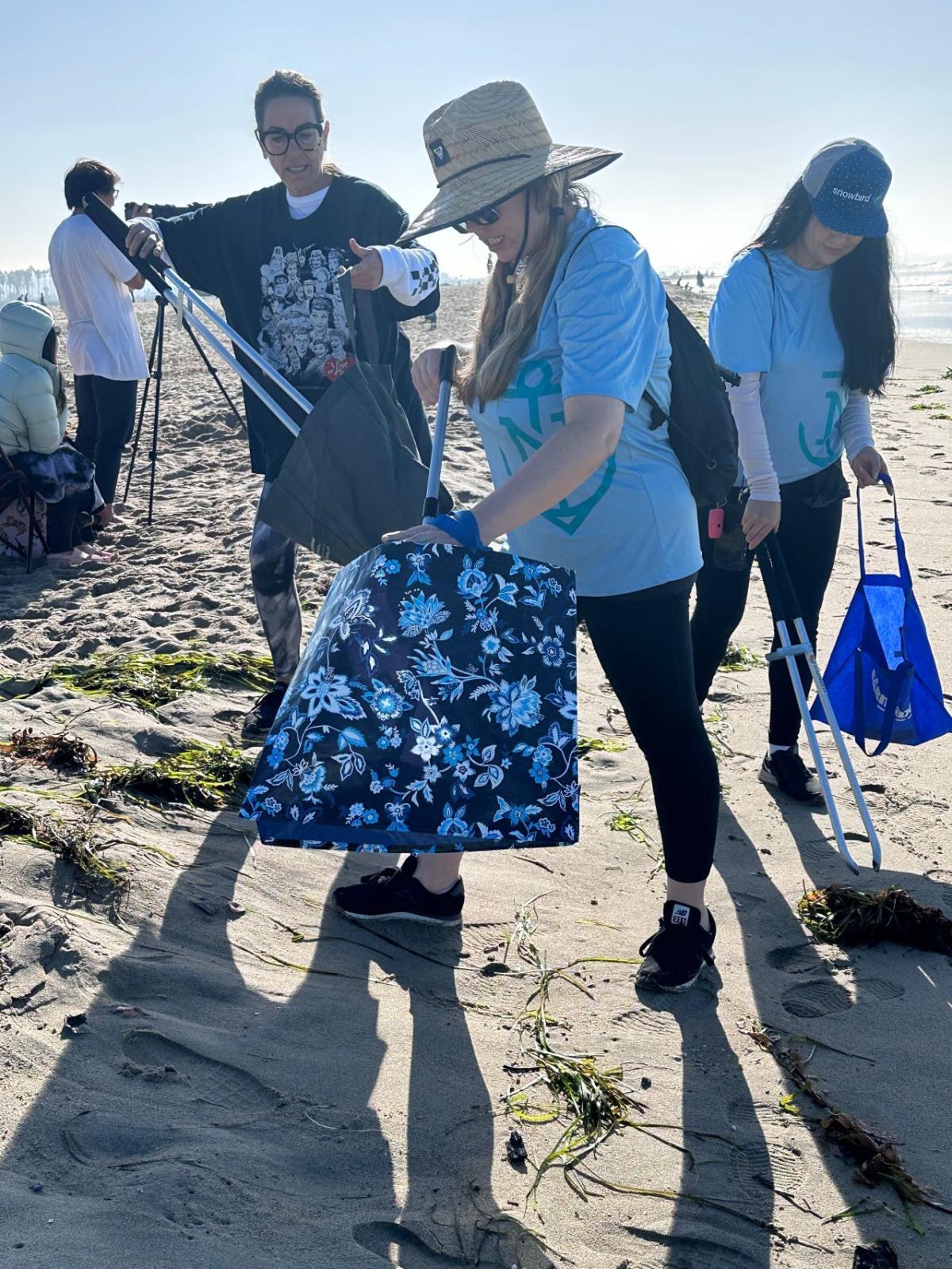 A group of volunteers cleaning up a beach.