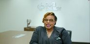 LaQuitta Gent, seated in a conference room. "Duke Energy" sign behind her.