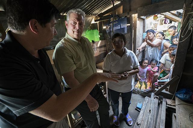 VP Al Gore with former Mayor of Tacloban City Alfred Romualdez and Typhoon Haiyan survivor Demi Raya, in the Raya family home; Tacloban City, Philippines, March 12, 2016
