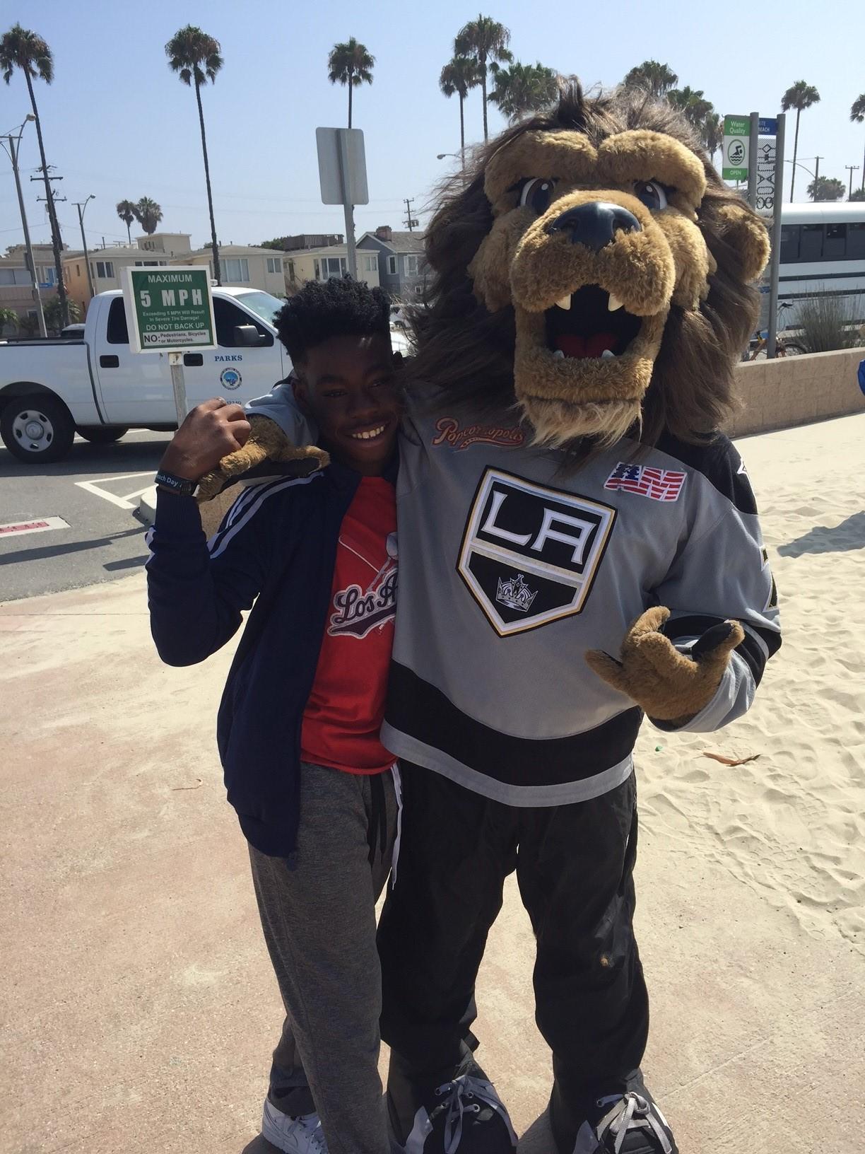AEG’s LA Kings mascot, Bailey, greets kids as they arrive for the Long Beach All-City Beach Day on August 11, 2017.