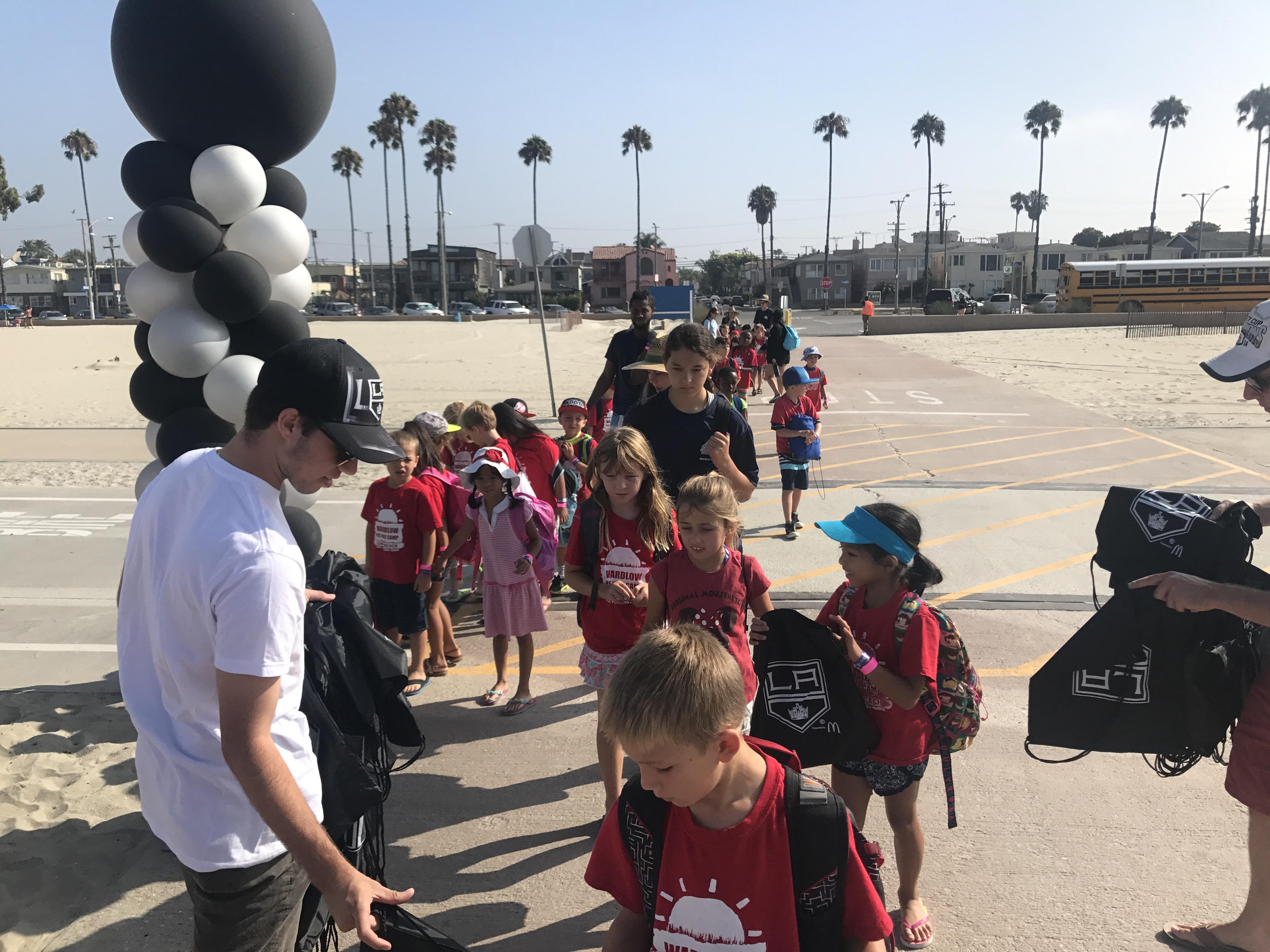 AEG’s LA Kings staff greet kids upon arrival at the Long Beach All-City Beach Day on August 11, 2017.