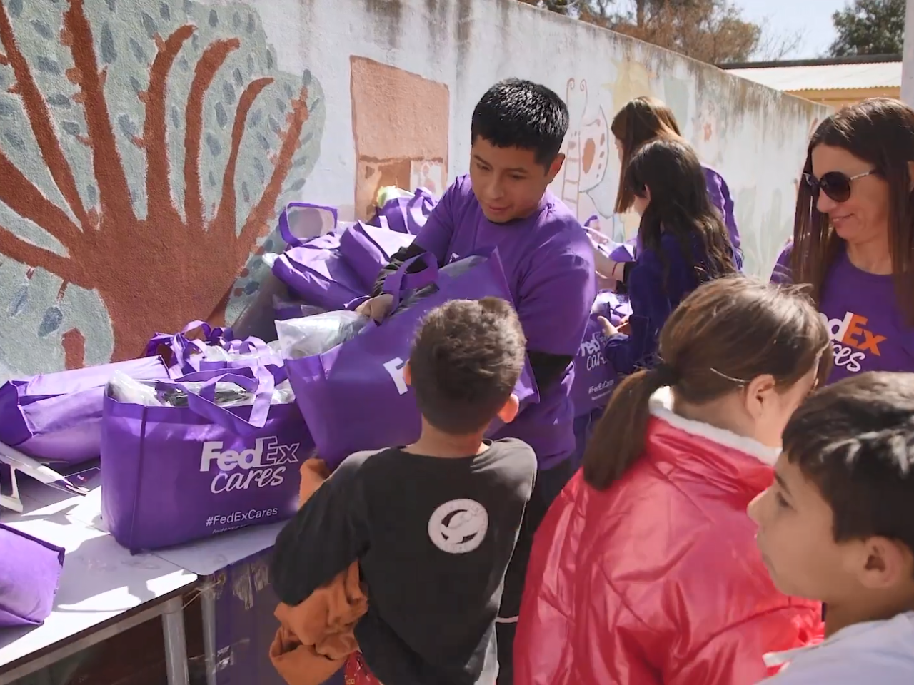 Volunteers giving bags to children