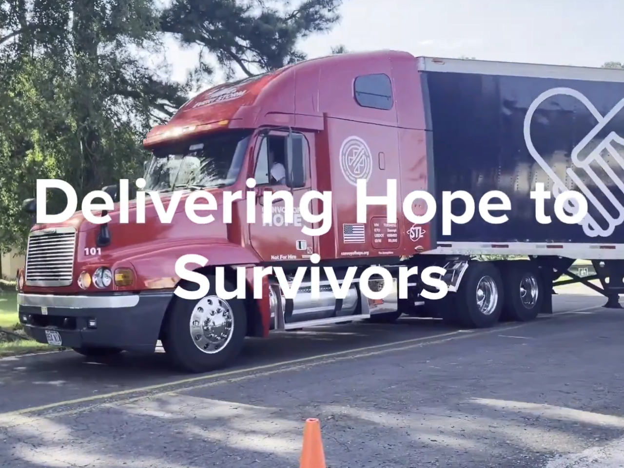 "Delivering Hope to Survivors" over a semi-truck making a turn.