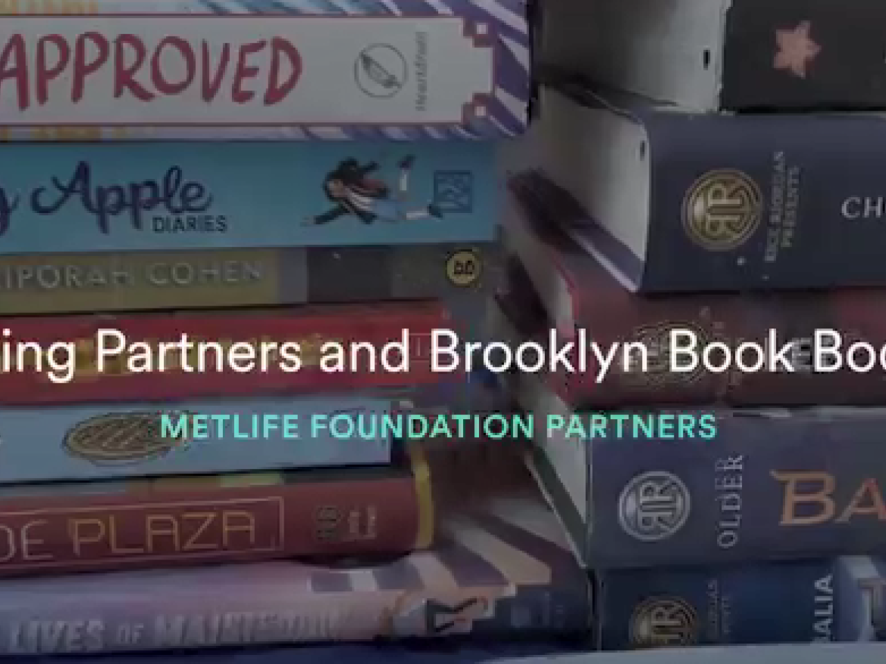 Close up of stacks of books. "Reading Partners and Brooklyn Book Bodega"