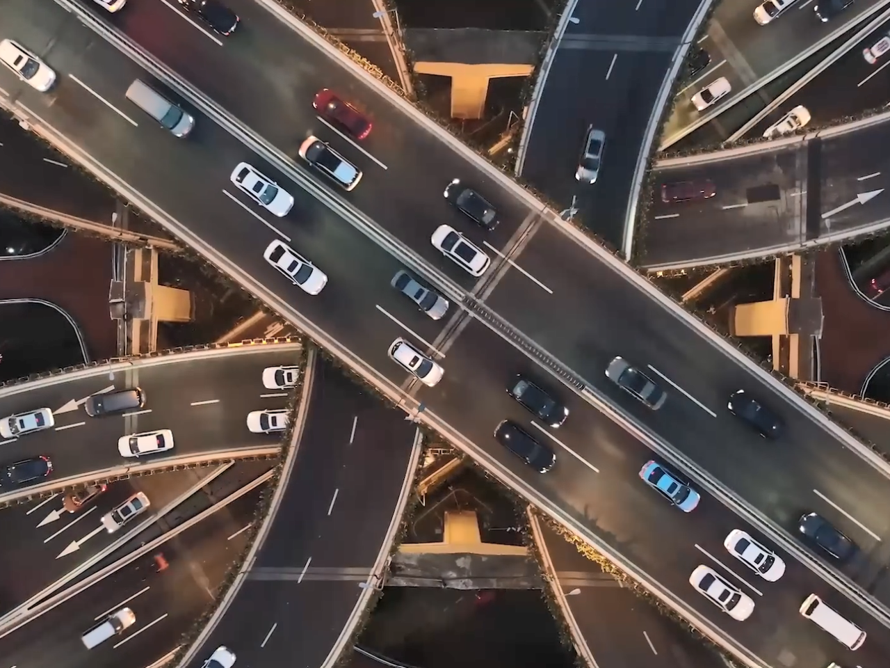 Aerial view of cars driving on multi-lane and multi-level highways.