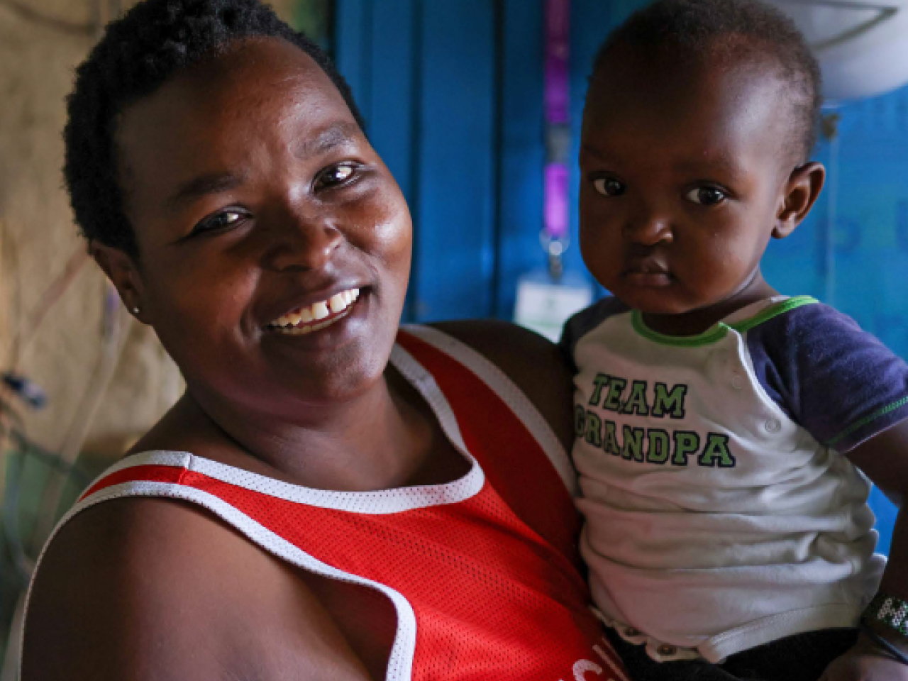 Woman holding child and smiling 