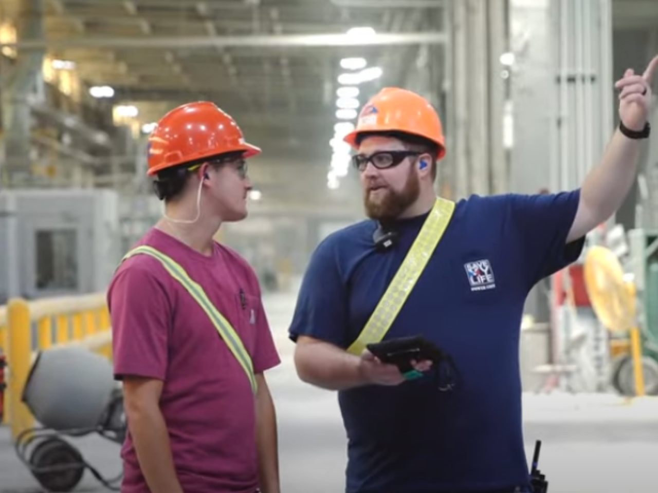 Two workers in orange hard hats