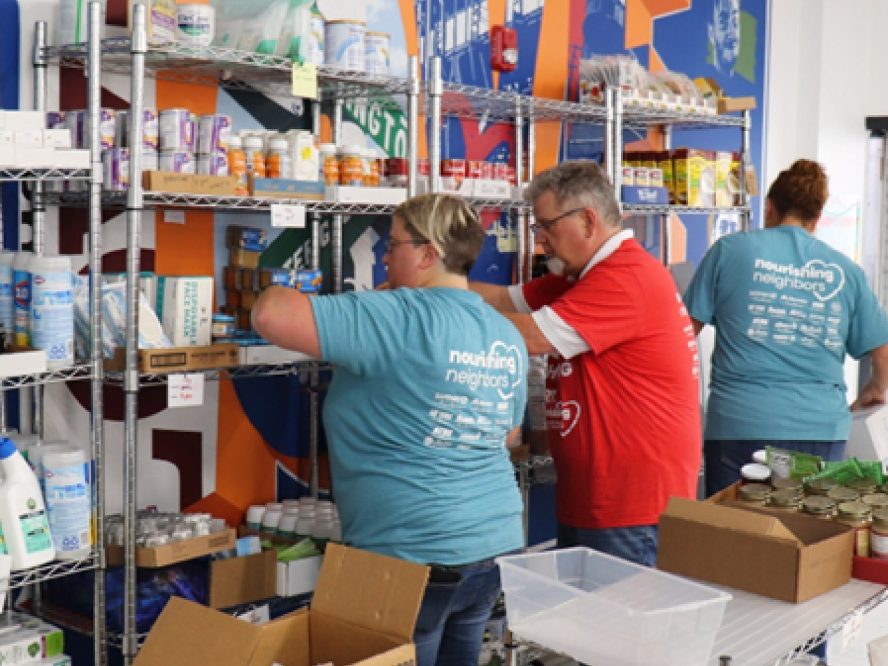 People stocking shelves in food pantry