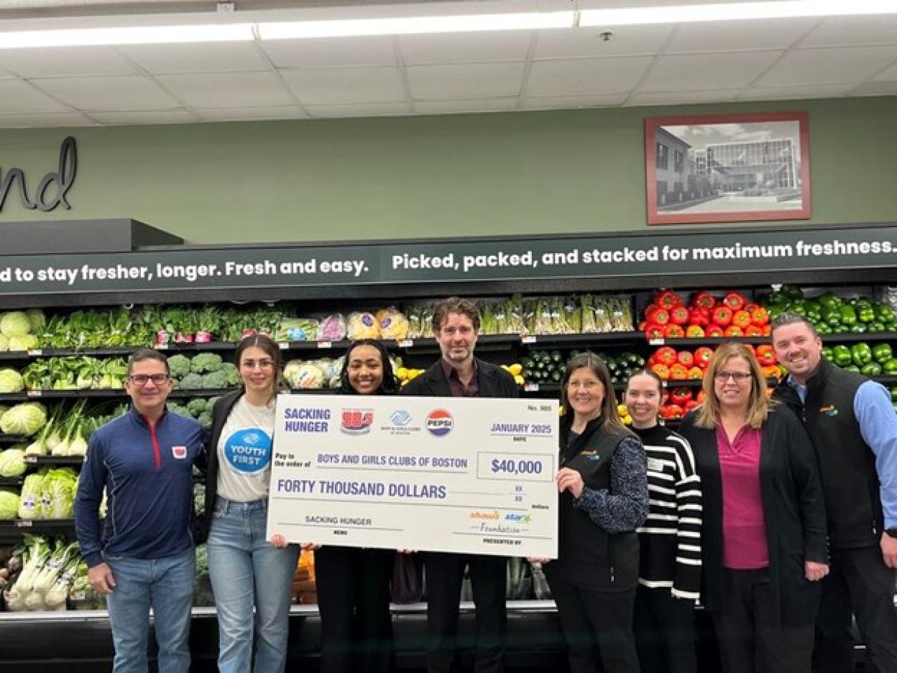 Group of people posing with check for $40,000