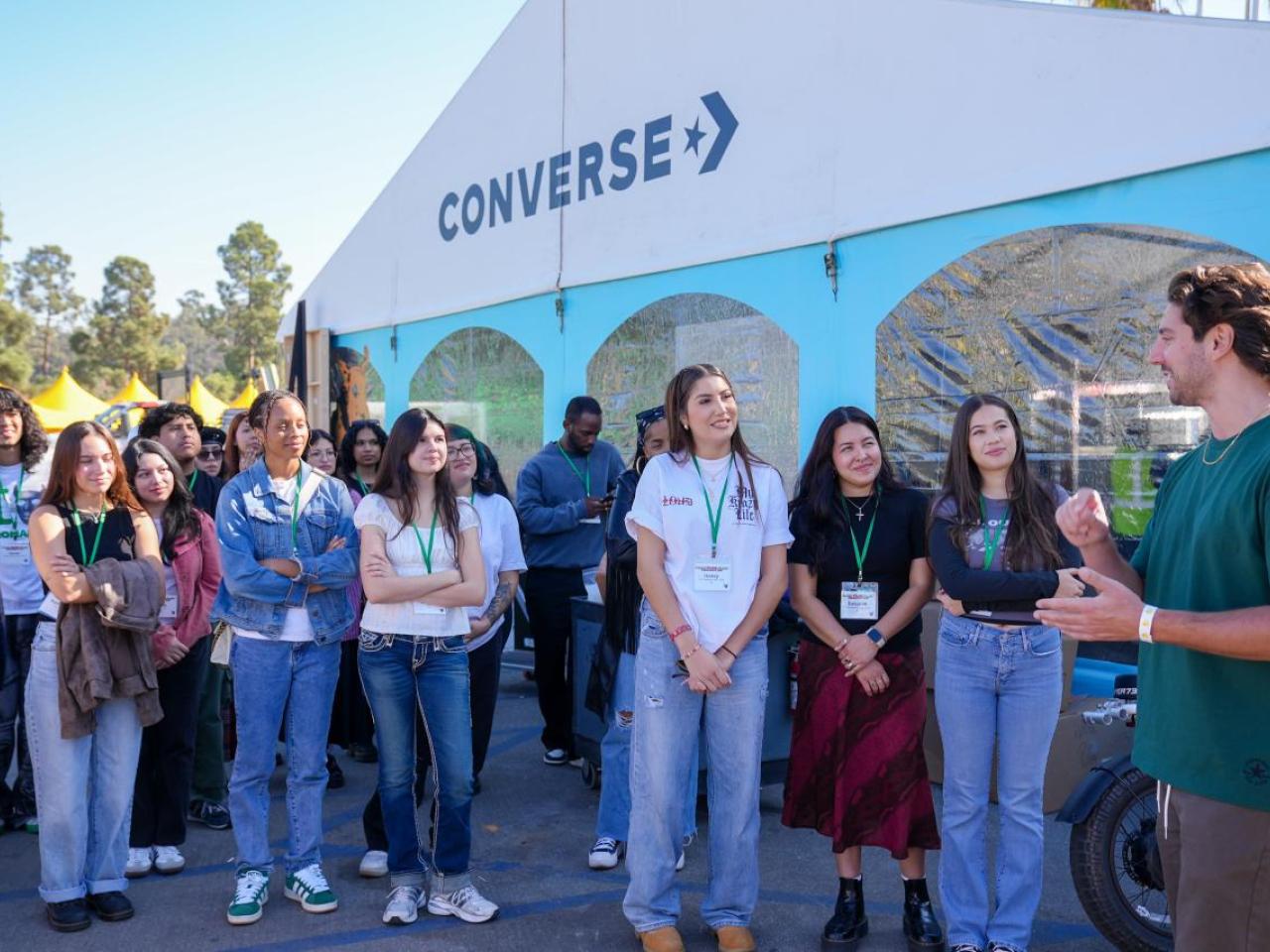 Group of students listening to speaker outside