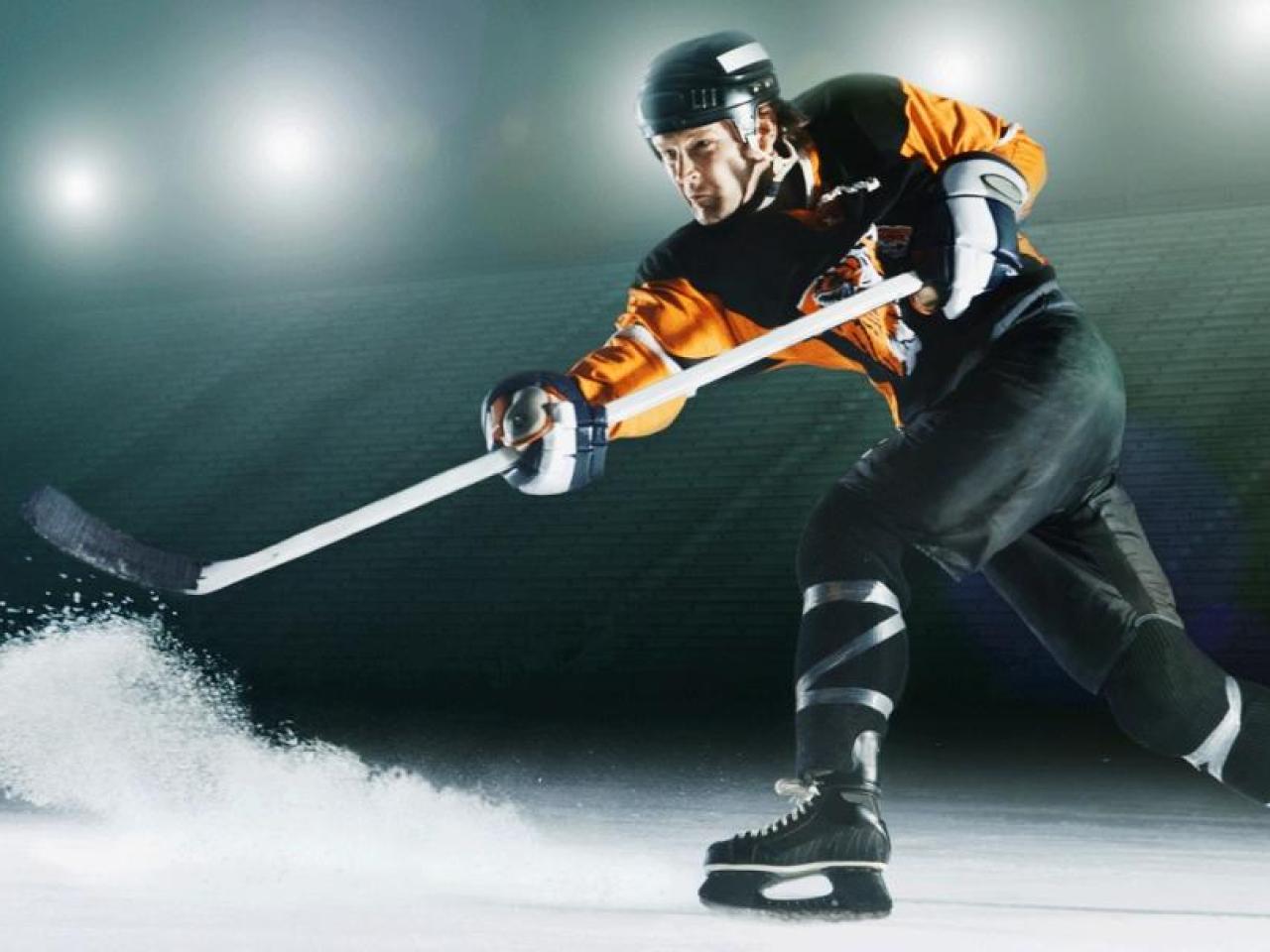 Hockey player hitting the puck