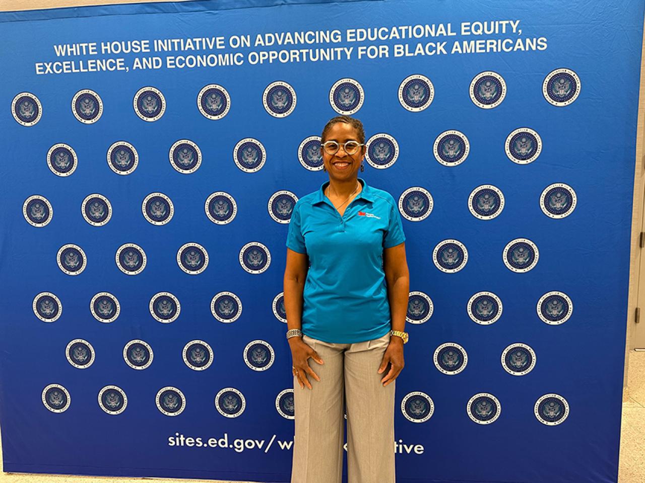 3M engineer Deboarh Isabelle shown in front of a banner stating: White House initiative on equity for Black Americans.