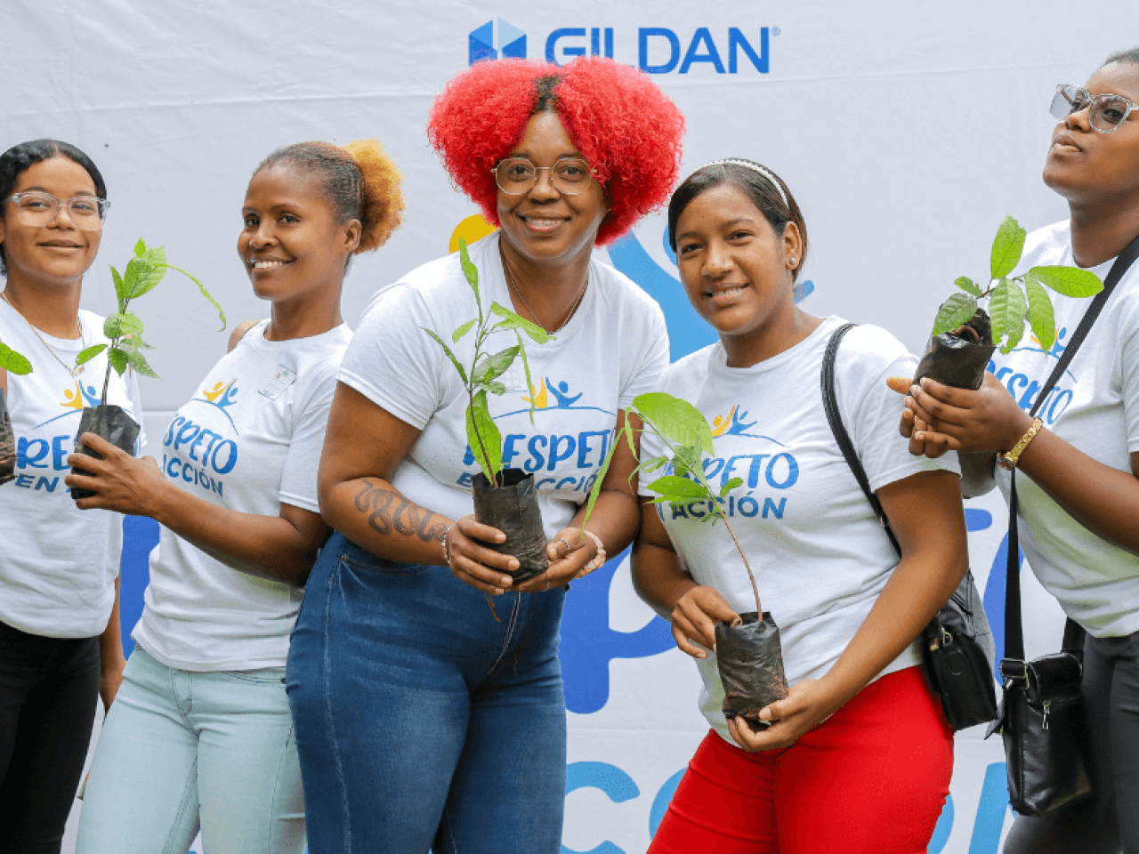 Five employees at a Gildan reforestation event