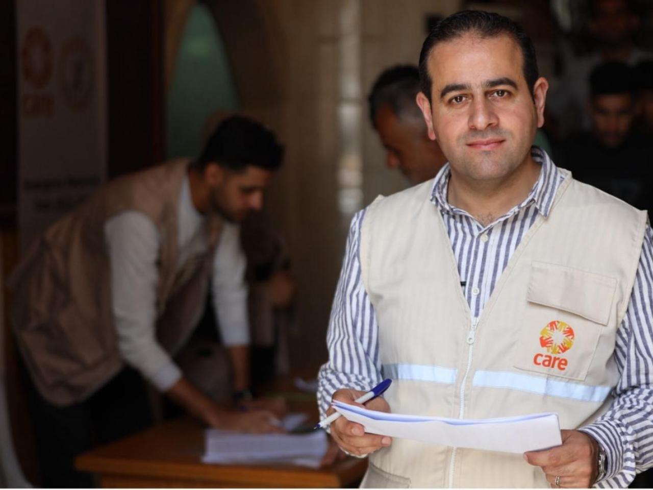 A man in an aid worker vest. 