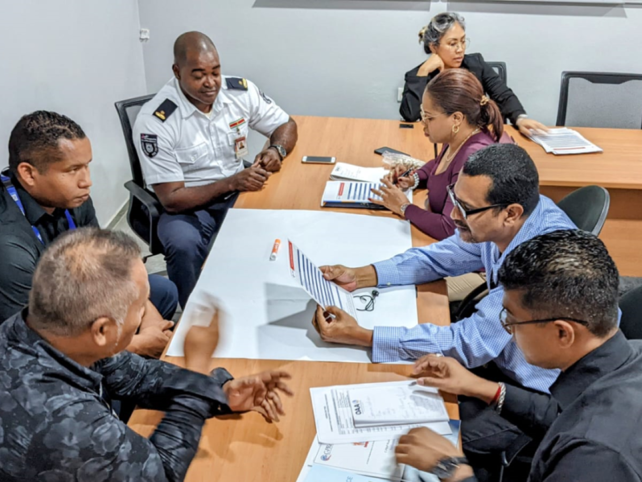 Group of seven people participating in tabletop exercise