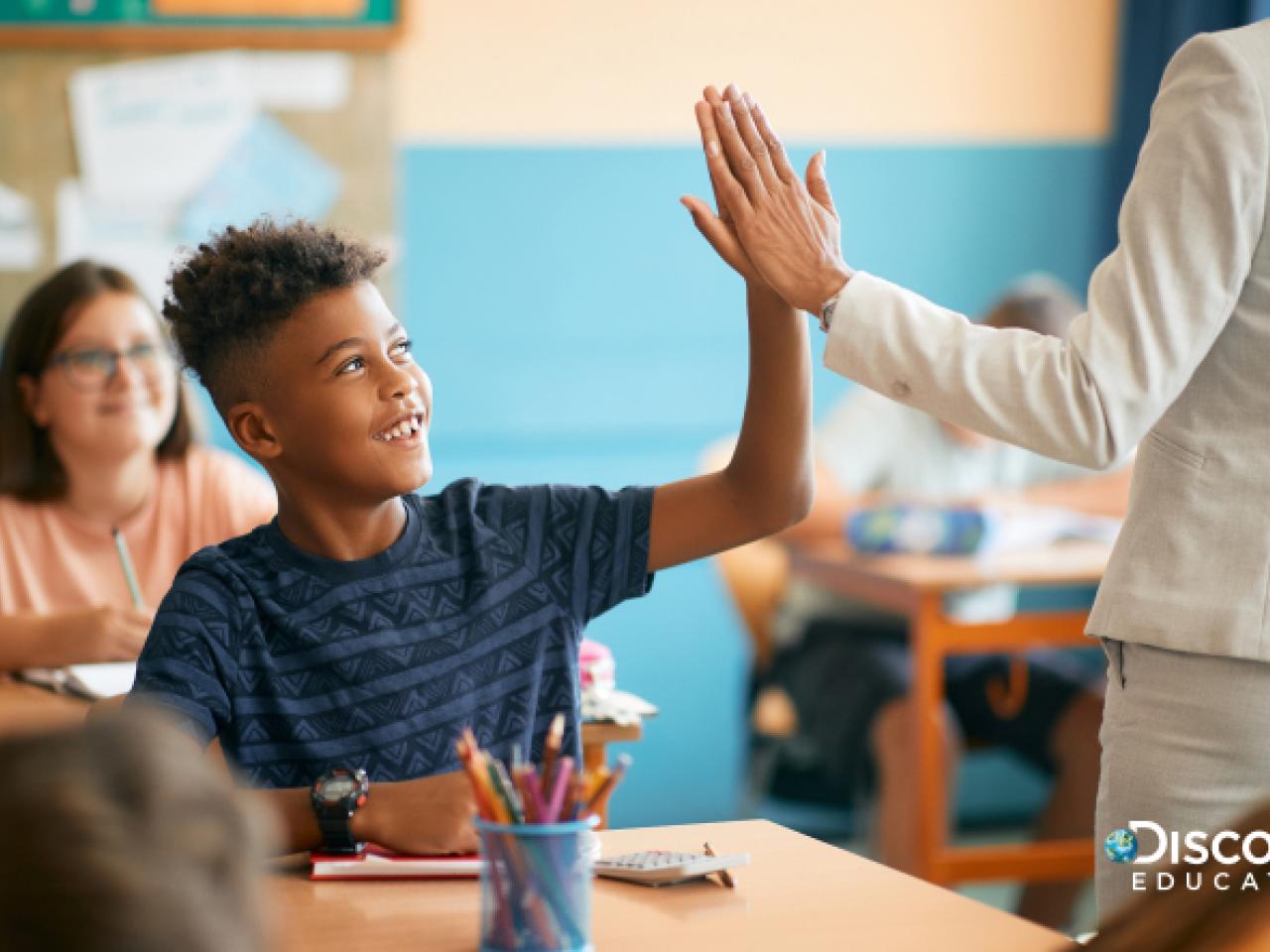 teacher high-fiving student