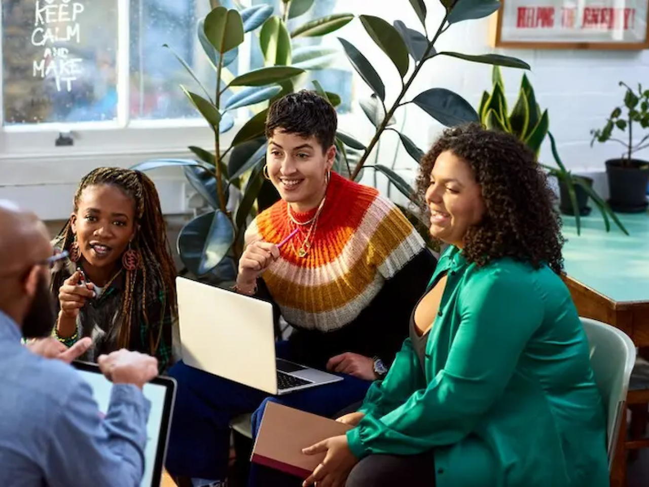 Group of four people sitting and chatting.