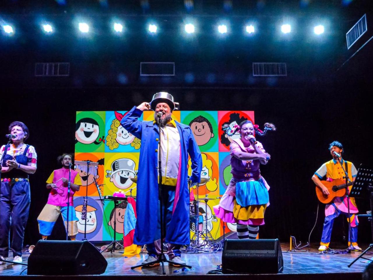 People in brightly colored clothing performing on a stage