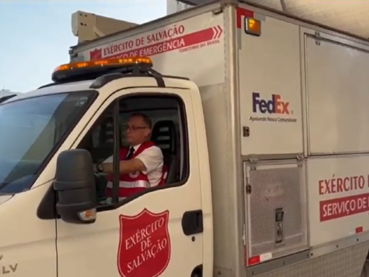 A person driving a Salvation Army FedEx vehicle