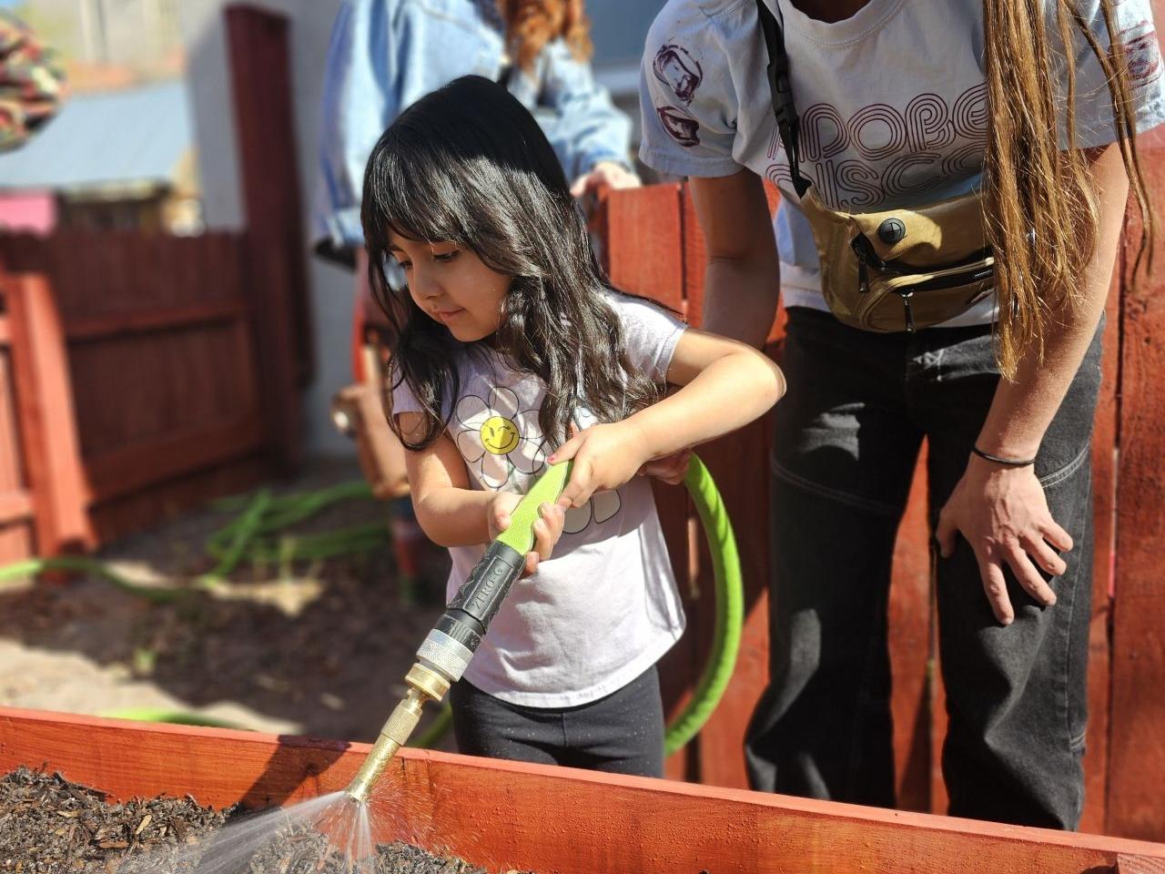 child and adult gardening together