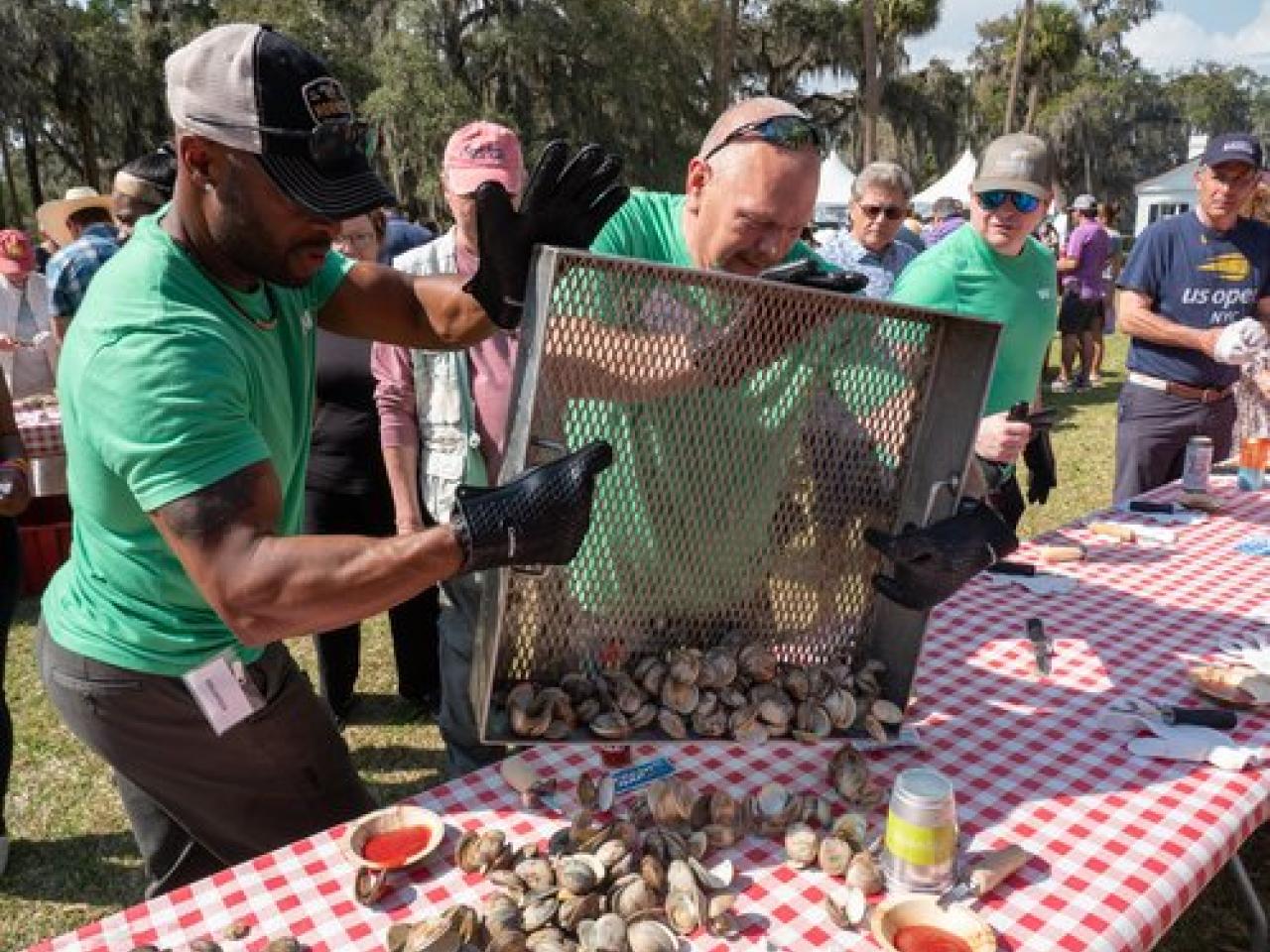 People dropping oysters onto a table