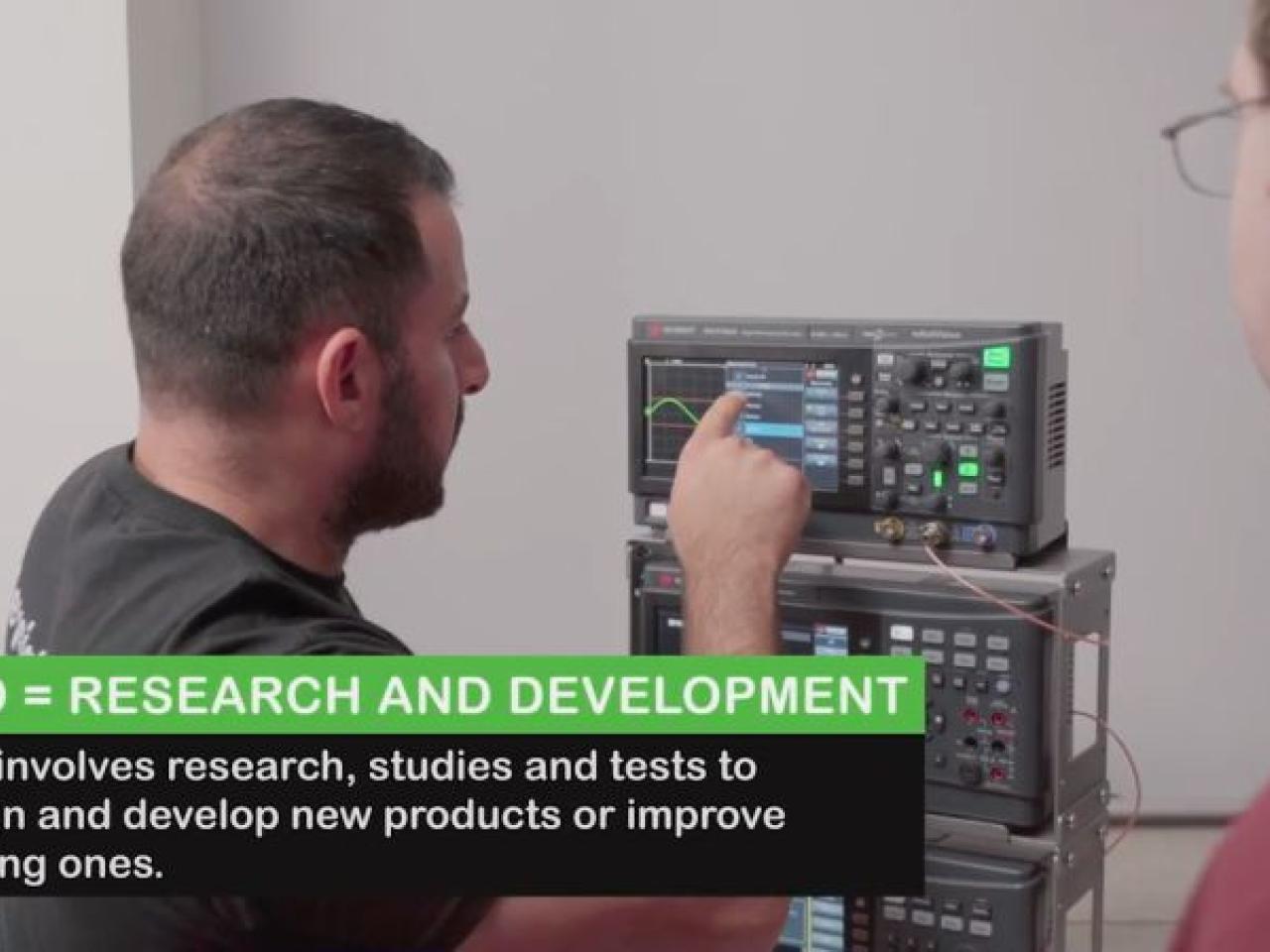 Two people looking at electronics, with text overlay reading: R & D = Research and Development. R & D involves research, studies and tests to design and develop new products or improve existing ones.