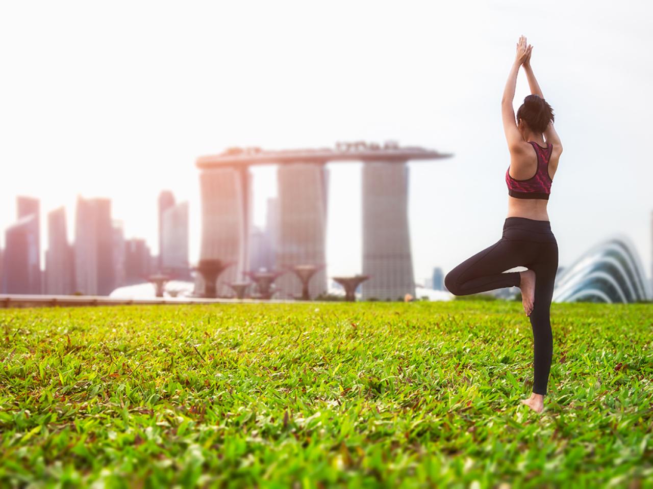 A person practicing yoga in the park