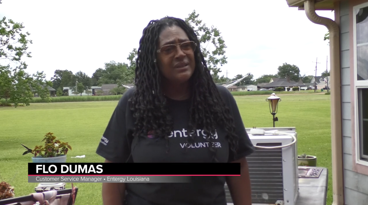 An Entergy volunteer speaks about the work the team is doing at a home.