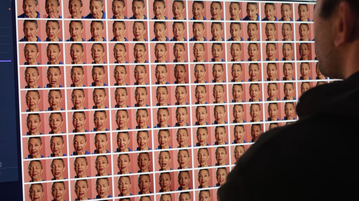 A large screen displaying multiple AI avatar faces