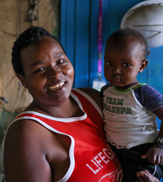 Woman holding child and smiling 