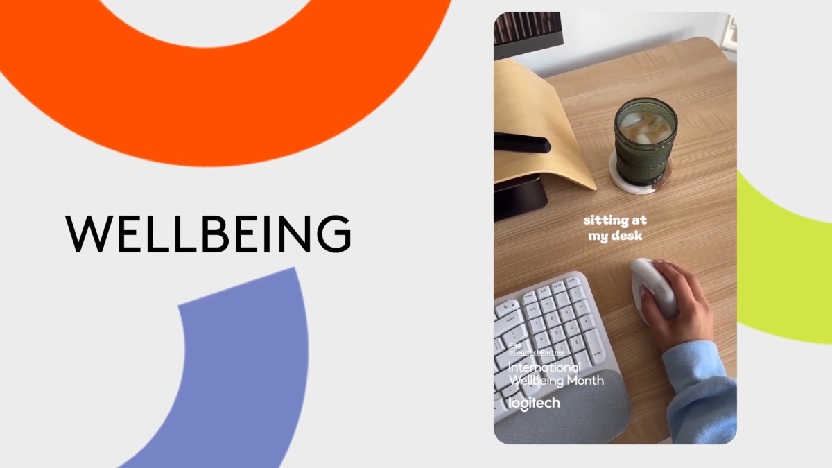 Th text "wellbeing" with a photo of a person using a mouse on a desk