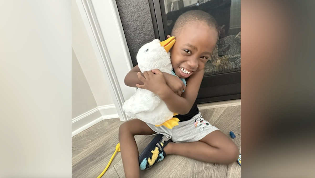 Young boy shown holding his Aflac Duck.