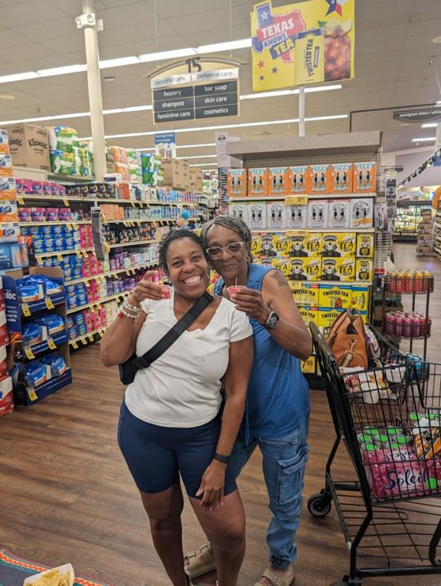 Two women posing for a picture in a store