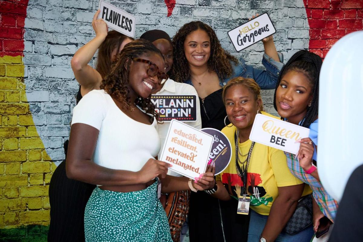 A group of young black women posing at a photo booth