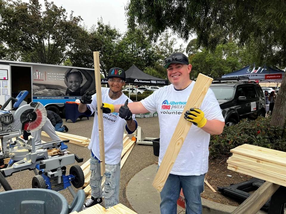 People posing with wood planks