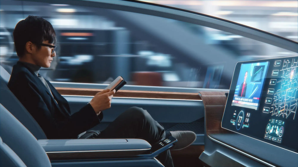 A person reading a book while riding in a car