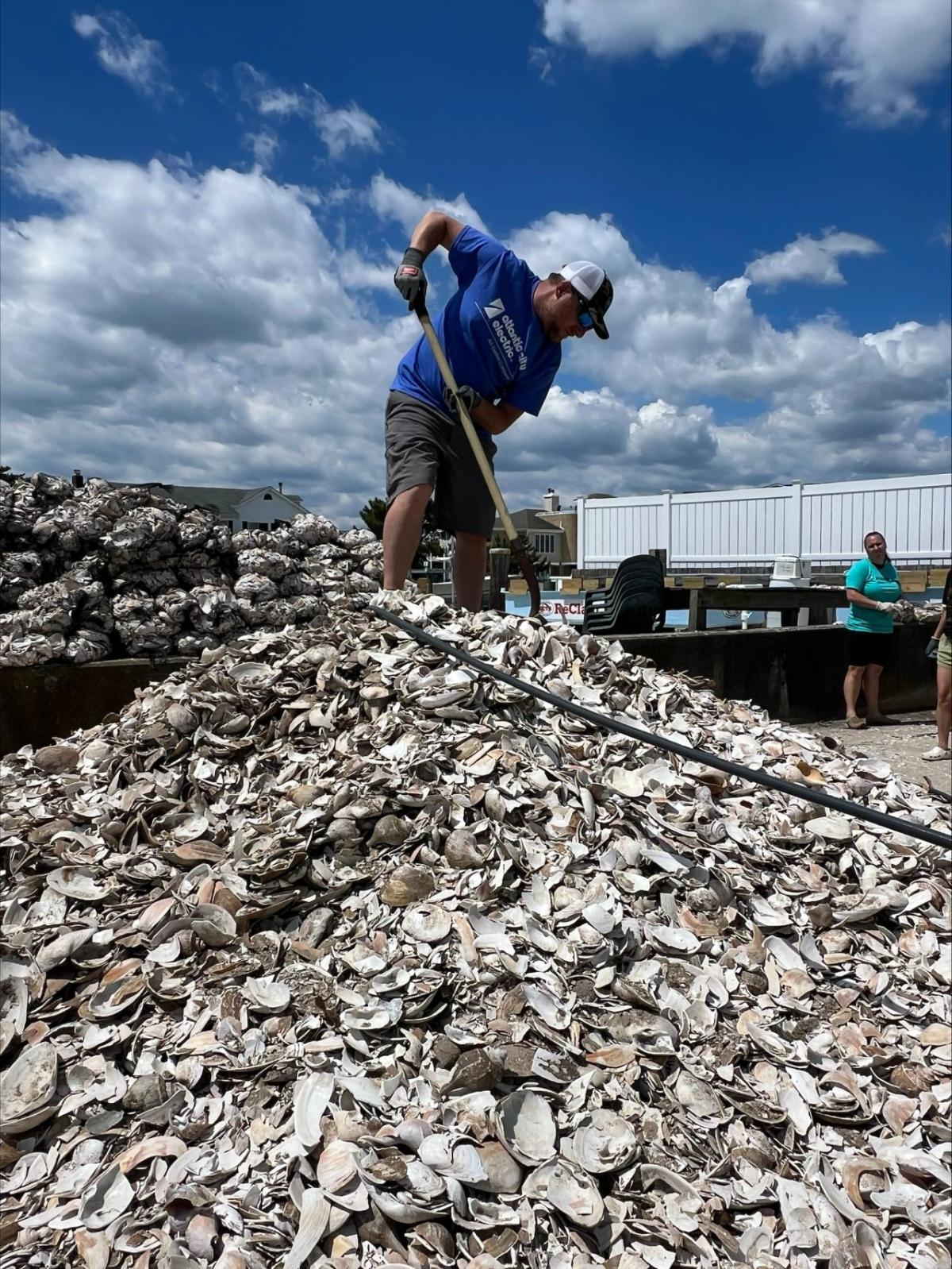 A person stood on top of a pile of shells