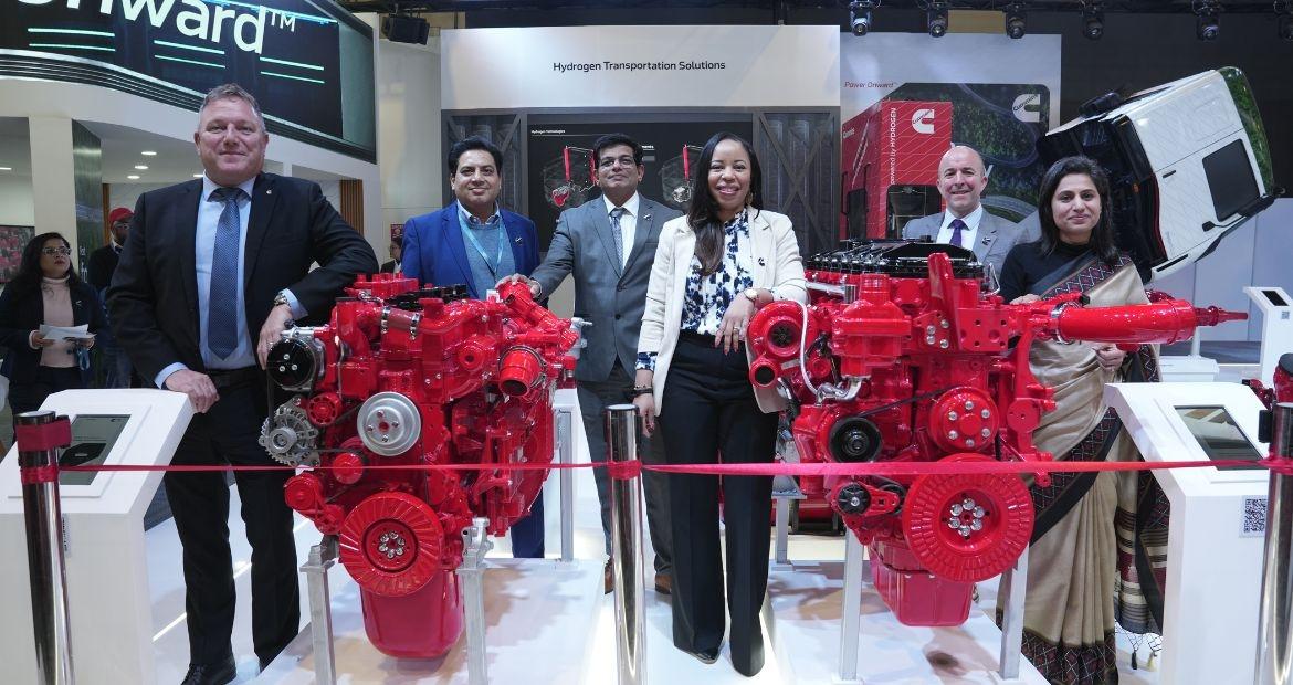 People posing with red engines