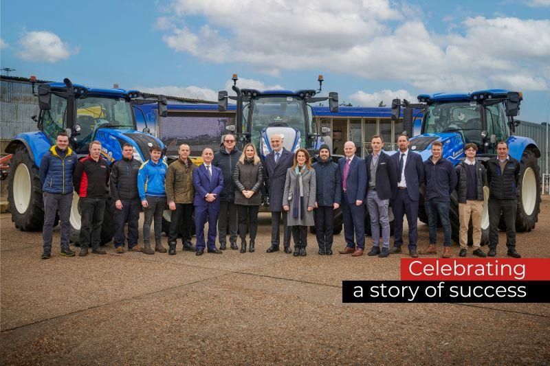 People standing together in front of blue machinery
