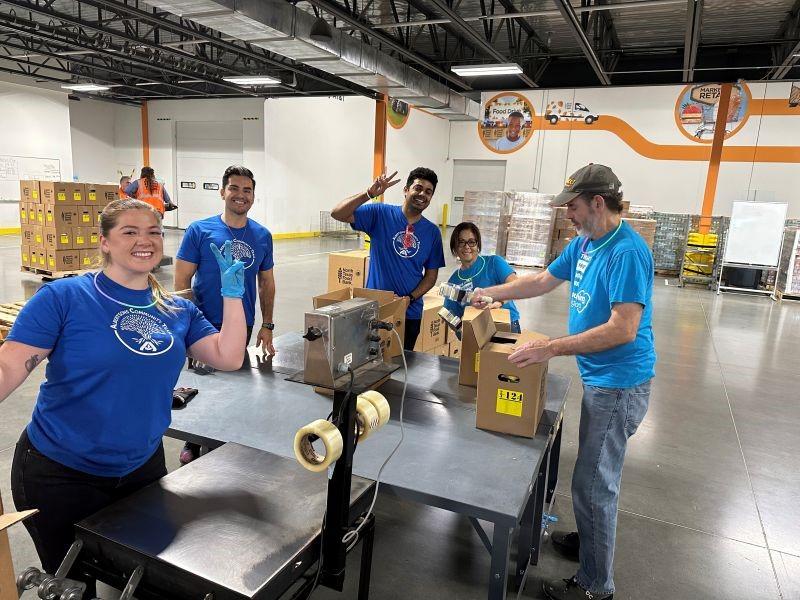 Albertsons associates packing up food boxes at North Texas Food Bank for donations.