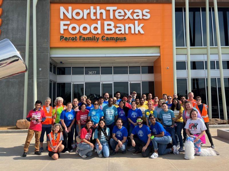 Albertsons associates pose for group picture in front of North Texas Food Bank.