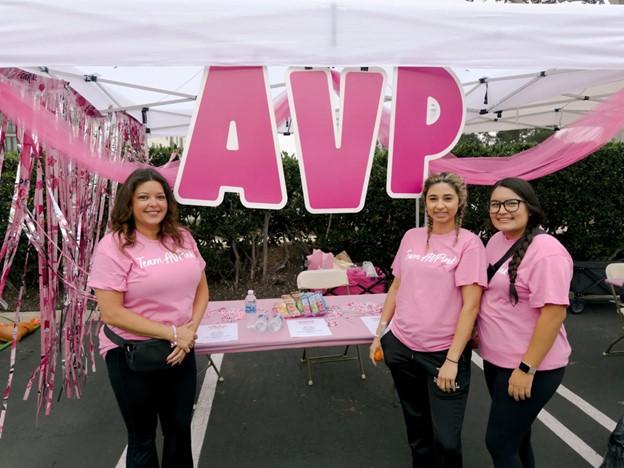 People at booth with "AVP" sign