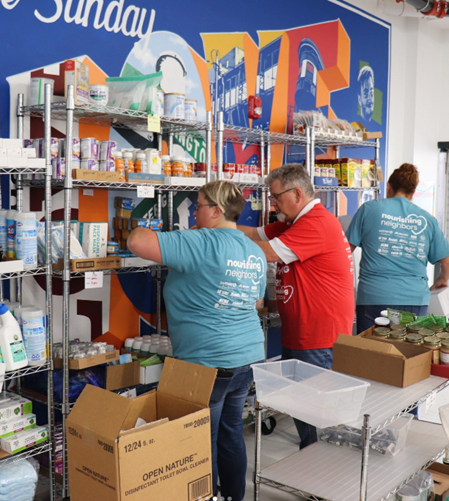 People stocking shelves in food pantry